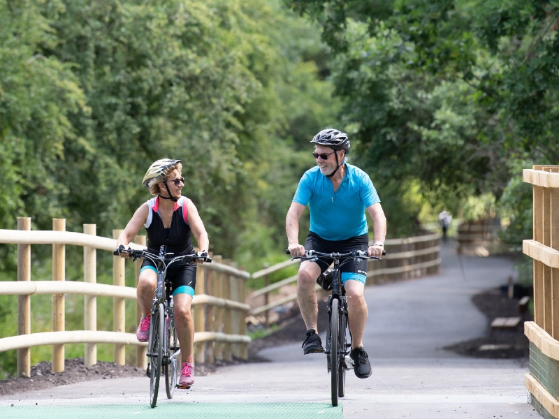 Two people cycling along the cyclepath at Blue Lias