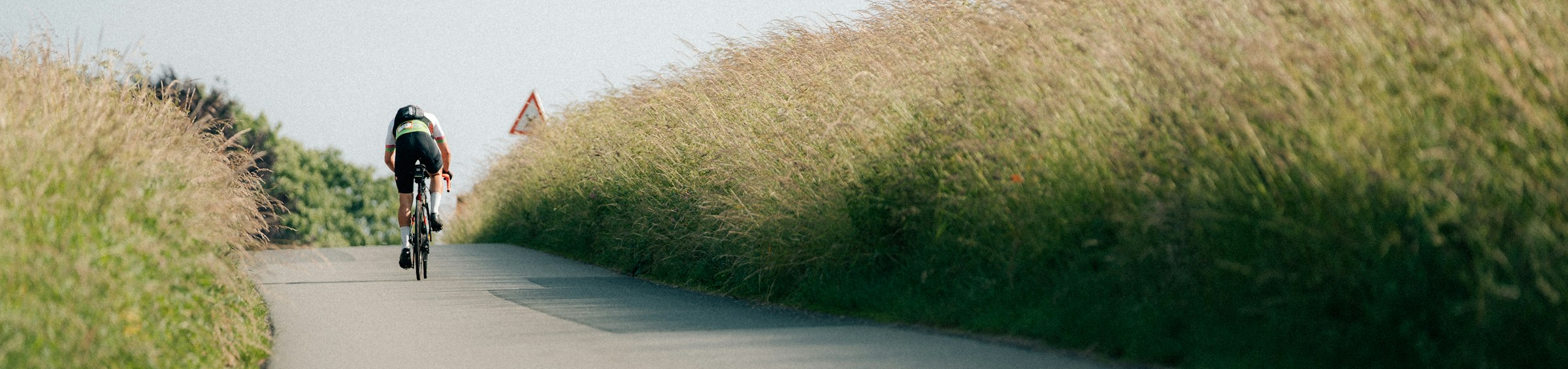Person cycling along a country lane